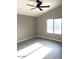 Bedroom with window, ceiling fan and grey wood-look flooring at 2618 S 81St Ln, Phoenix, AZ 85043