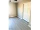 Bedroom with closet, natural light, and contemporary gray vinyl flooring at 2618 S 81St Ln, Phoenix, AZ 85043