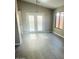 Dining area features large window, modern light fixture and new gray vinyl floors at 2618 S 81St Ln, Phoenix, AZ 85043