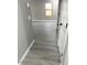 Well-lit hallway with new gray flooring that flows seamlessly throughout the home's interior at 2618 S 81St Ln, Phoenix, AZ 85043