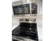 Close-up of a stainless steel stove and microwave with a white backsplash at 2618 S 81St Ln, Phoenix, AZ 85043