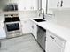 Bright kitchen featuring white cabinets, stainless steel appliances, and a modern black faucet at 2618 S 81St Ln, Phoenix, AZ 85043