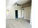 Spacious living room featuring new gray flooring, large doors, and a stylish ceiling fan at 2618 S 81St Ln, Phoenix, AZ 85043