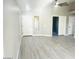 Open-concept living room with vaulted ceilings and modern gray flooring that flows throughout the home at 2618 S 81St Ln, Phoenix, AZ 85043