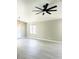 Open living room featuring light-colored floors and a modern ceiling fan at 2618 S 81St Ln, Phoenix, AZ 85043