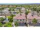 Scenic aerial view highlighting condos, palm trees, and nearby commercial areas with lush surroundings at 2801 N Litchfield Rd # 37, Goodyear, AZ 85395