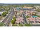 Scenic aerial view of the condos, pool, palm trees, and the neighboring community at 2801 N Litchfield Rd # 37, Goodyear, AZ 85395