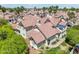 An elevated aerial view of condos with red tile roofs, blue umbrellas, and lush landscaping at 2801 N Litchfield Rd # 37, Goodyear, AZ 85395