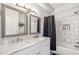 Bathroom features a double sink vanity with marble countertop, decorative mirrors and tiled shower with a bathtub at 2801 N Litchfield Rd # 37, Goodyear, AZ 85395