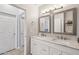 Bathroom features a double vanity with marble countertop, decorative mirrors, and access to the Primary bedroom at 2801 N Litchfield Rd # 37, Goodyear, AZ 85395