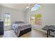 Well-lit bedroom with tile floors, vaulted ceiling, large windows, and a comfortable bed at 2801 N Litchfield Rd # 37, Goodyear, AZ 85395