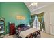 Bright bedroom featuring a floral-patterned bed, complemented by a high ceiling and natural light from the window at 2801 N Litchfield Rd # 37, Goodyear, AZ 85395