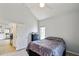 Bedroom features tile flooring, a vaulted ceiling, and an open doorway leading to other areas of the home at 2801 N Litchfield Rd # 37, Goodyear, AZ 85395