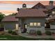 Charming home with a red tile roof, manicured lawn, and inviting blue front door at sunset at 2801 N Litchfield Rd # 37, Goodyear, AZ 85395