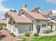 Charming condo featuring a terra cotta tile roof, blue front door, and well-maintained landscaping at 2801 N Litchfield Rd # 37, Goodyear, AZ 85395