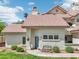 Inviting condo showcasing a terra cotta tile roof, blue front door, and meticulously kept front yard at 2801 N Litchfield Rd # 37, Goodyear, AZ 85395