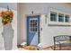 Inviting blue front door with flower basket, welcome mat, and wrought-iron bench at 2801 N Litchfield Rd # 37, Goodyear, AZ 85395
