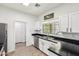 Modern kitchen with stainless steel appliances, sleek black countertops, and bright white cabinets at 2801 N Litchfield Rd # 37, Goodyear, AZ 85395