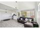 Bright, open-concept living area with a plush leather couch and lots of natural light at 2801 N Litchfield Rd # 37, Goodyear, AZ 85395