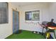 Inviting patio with artificial grass, a grill, a door to the home, and a window at 2801 N Litchfield Rd # 37, Goodyear, AZ 85395