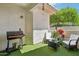 Charming patio area with artificial grass, a grill, and comfortable seating surrounded by lush greenery at 2801 N Litchfield Rd # 37, Goodyear, AZ 85395