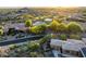 Stunning aerial view of a desert home surrounded by lush landscaping and a nearby golf course at 29412 N 108Th Pl, Scottsdale, AZ 85262