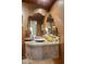Unique bathroom showcasing a stone sink, a sculpted mirror, decorative candles and warm earthy tones at 29412 N 108Th Pl, Scottsdale, AZ 85262