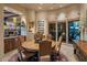 Formal dining area with circular wood table, decorative rug and view to the outdoor space at 29412 N 108Th Pl, Scottsdale, AZ 85262
