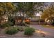 Charming home featuring desert landscaping with mature trees and a spacious driveway to a two-car garage at 29412 N 108Th Pl, Scottsdale, AZ 85262