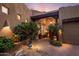 Inviting covered entryway with lush greenery, potted plants, and warm lighting at 29412 N 108Th Pl, Scottsdale, AZ 85262