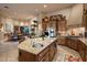 Kitchen island and dining area with wood cabinetry and natural lighting at 29412 N 108Th Pl, Scottsdale, AZ 85262