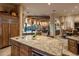 Kitchen island with granite counter top and sink that looks into living and dining spaces at 29412 N 108Th Pl, Scottsdale, AZ 85262