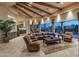 Spacious living room with beamed ceilings, tile floors, and backyard views at 29412 N 108Th Pl, Scottsdale, AZ 85262