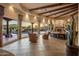 Inviting living room showcasing wooden beams, tile flooring, and expansive windows overlooking desert landscaping at 29412 N 108Th Pl, Scottsdale, AZ 85262