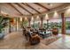 Expansive living room boasts wood-beamed ceilings, tile flooring, and oversized sliding glass doors that provide views at 29412 N 108Th Pl, Scottsdale, AZ 85262