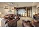 Well-appointed living room featuring leather sofas, a large screen, shelving, and stylish decorations at 29412 N 108Th Pl, Scottsdale, AZ 85262