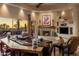 Inviting living room with a cozy fireplace, comfortable seating, and views of the desert landscape at 29412 N 108Th Pl, Scottsdale, AZ 85262