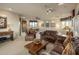 Spacious living room with plush leather furniture, a projector and plenty of light at 29412 N 108Th Pl, Scottsdale, AZ 85262