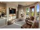 Bedroom with fireplace, sitting area, and access to the patio and pool area at 29412 N 108Th Pl, Scottsdale, AZ 85262