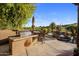 Outdoor kitchen and covered lounge area next to a lovely pool with a waterfall feature at 29412 N 108Th Pl, Scottsdale, AZ 85262