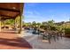 A lovely pool area with a covered patio, water feature and desert landscaping at 29412 N 108Th Pl, Scottsdale, AZ 85262