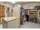 Walk-in closet with built-in shelves, cabinets, and center island at 29412 N 108Th Pl, Scottsdale, AZ 85262