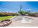 Backyard with lawn, shed, mature landscaping, stone fire pit, and swimming pool awaiting water at 3109 N 81St St, Scottsdale, AZ 85251