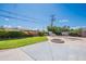 Green backyard with lawn, lush landscaping, empty pool, and outdoor stone fire pit at 3109 N 81St St, Scottsdale, AZ 85251