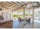 Backyard patio with comfortable wicker furniture, ceiling fan, stone-covered bar and outdoor grill at 3109 N 81St St, Scottsdale, AZ 85251