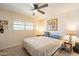 Bedroom with a ceiling fan, window, framed picture, lamps, and queen sized bed at 3109 N 81St St, Scottsdale, AZ 85251