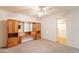 Bedroom with a ceiling fan, doorway, and built-in wood headboard with storage at 3109 N 81St St, Scottsdale, AZ 85251