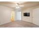 Bedroom with a ceiling fan, doorway, closet, television, and carpeted floor at 3109 N 81St St, Scottsdale, AZ 85251