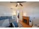Bedroom with a fireplace, ceiling fan, doorway to another room, and accent chair at 3109 N 81St St, Scottsdale, AZ 85251