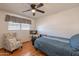 Cozy bedroom features a ceiling fan, large window, and an accent chair at 3109 N 81St St, Scottsdale, AZ 85251